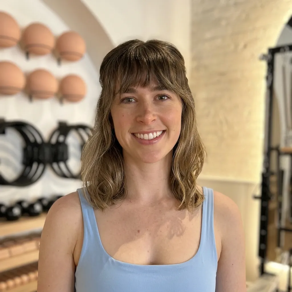 Jorja Mandy, certified Pilates instructor, smiling headshot